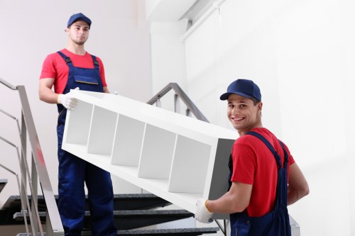 Removal team using safe handling methods during a house move