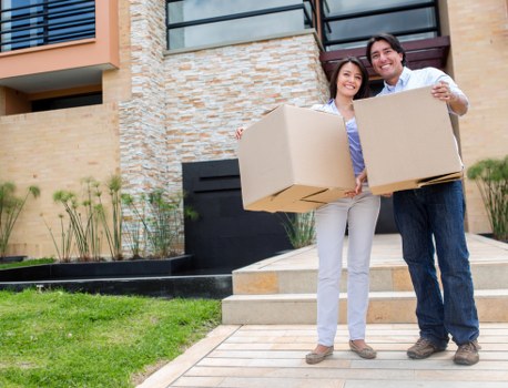 Removal crew carrying furniture during a Barnes house move